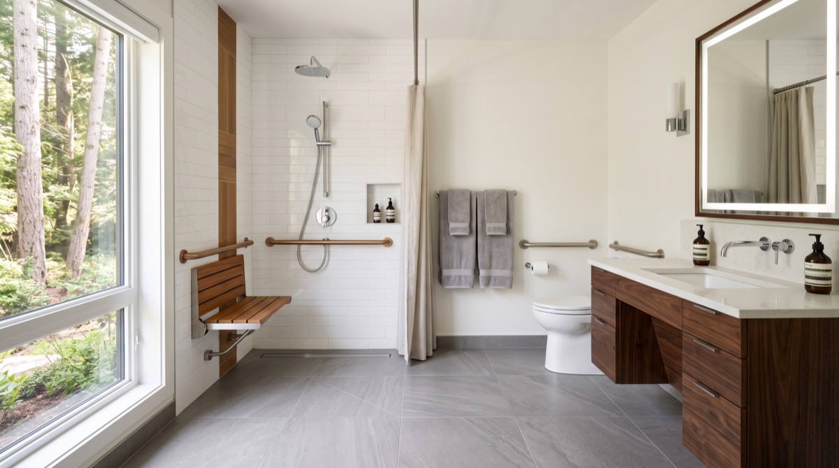 Accessible curbless walk-in shower with grab bars in Calgary